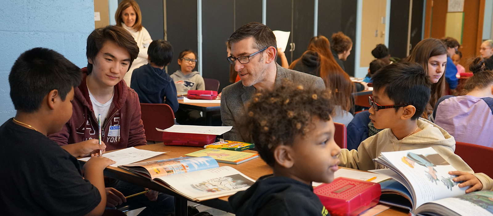 Asst. Teaching Prof. Matt Hurwitz helps students work with grade-schoolers