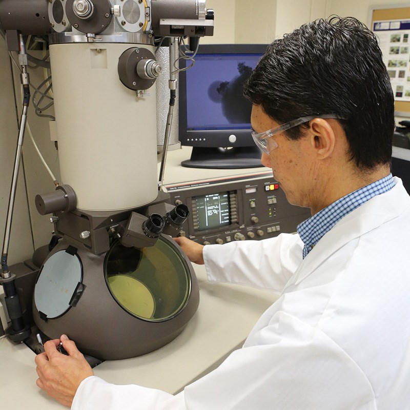 Man looking at piece of equipment in Material Characterization lab