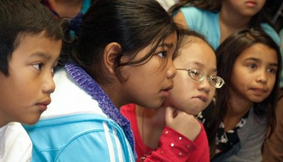 young students of color listening