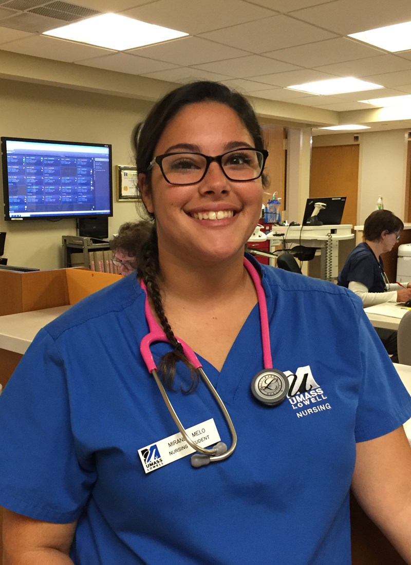 Headshot of Miranda Melo working at a hospital in UML scrubs