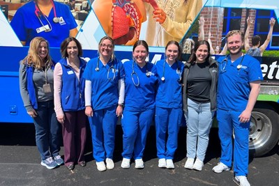 Nursing students standing in front of Mobile Health Unit