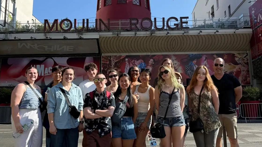 Group of students in front of Moulin Rouge sign