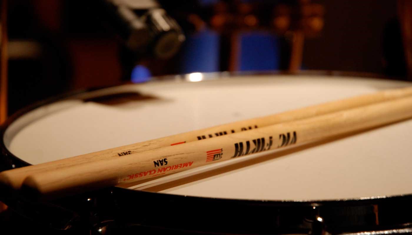 Drum sticks resting on a snare drum