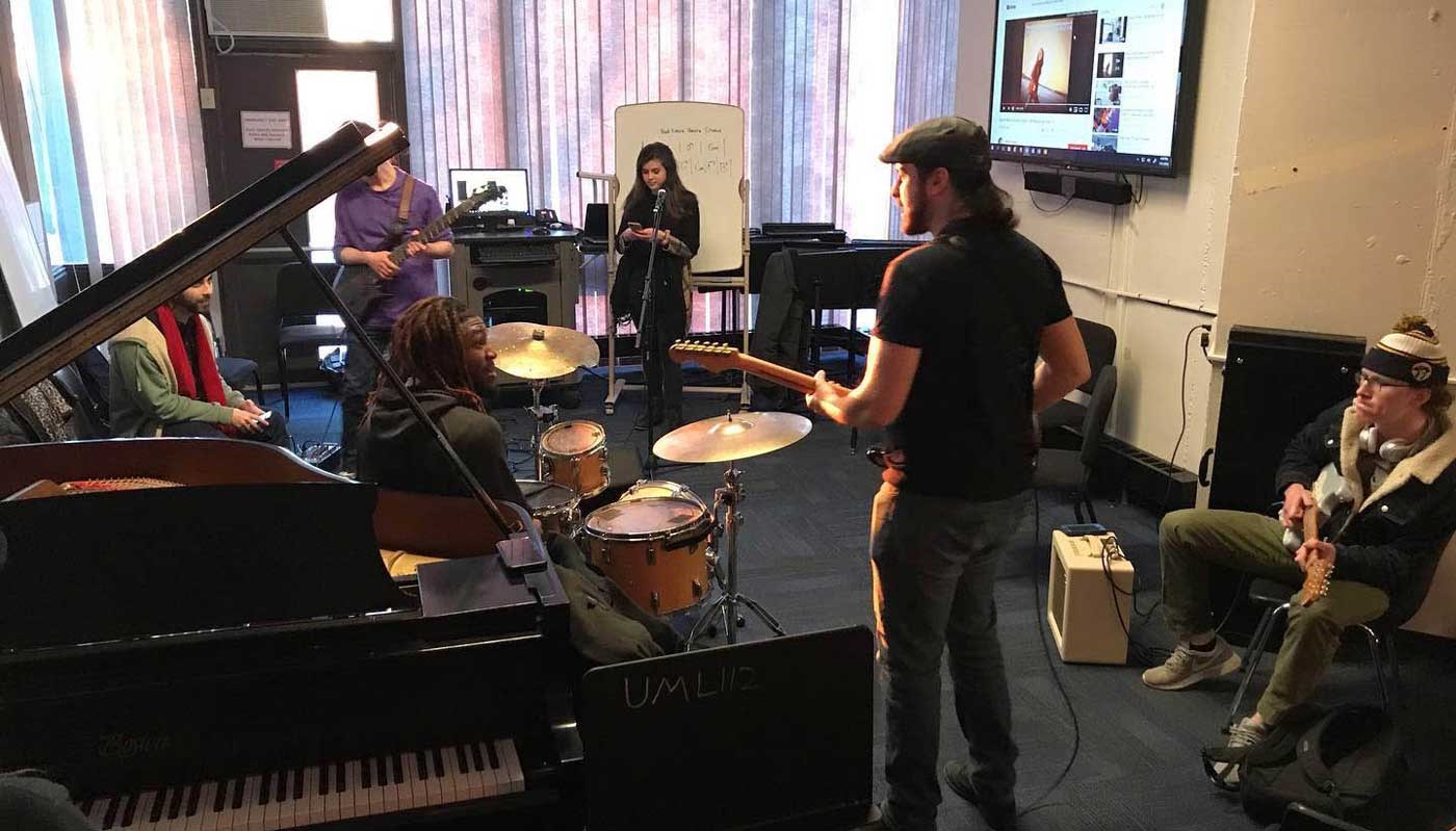 Students from the Songwriting Ensemble rehearse in a UMass Lowell studio