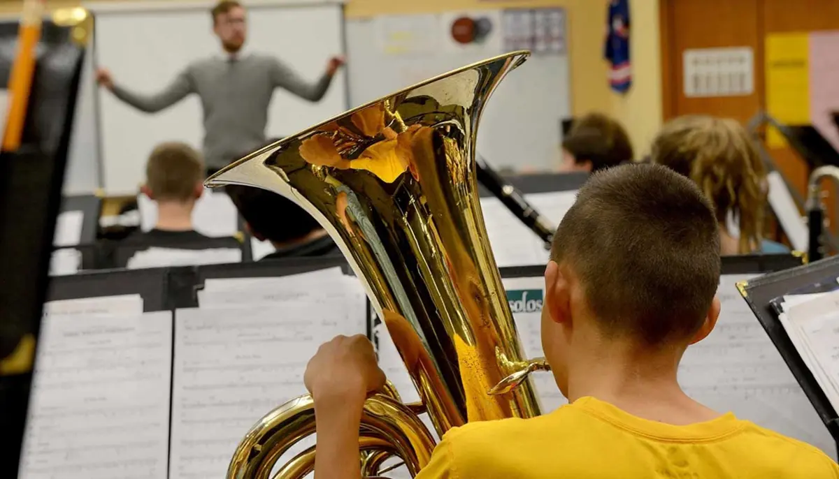 Young boy playing the tuba in a wind ensemble