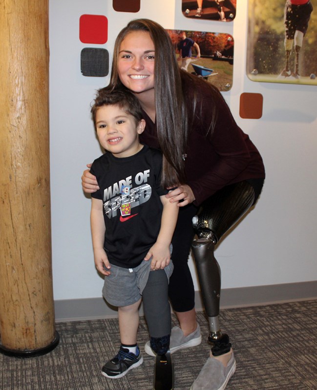 Noelle Lambert poses with 3-year-old Isaak Depelteau, who had a prosthetic blade donated to him by the Born to Run Foundation.