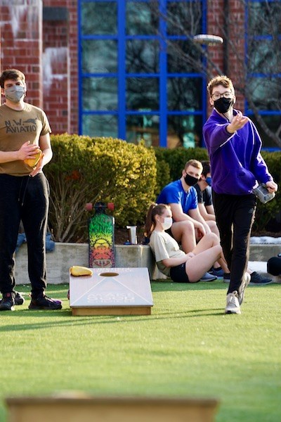 students play cornhole outside the Campus Rec Center