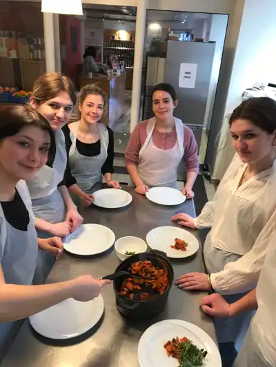4 UMass Lowell students with an instructor at a cooking class in Paris, France.