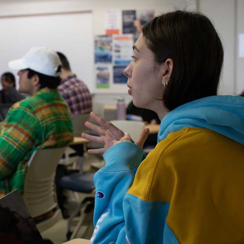 Students sit at desks in philosophy classroom at UMass Lowell