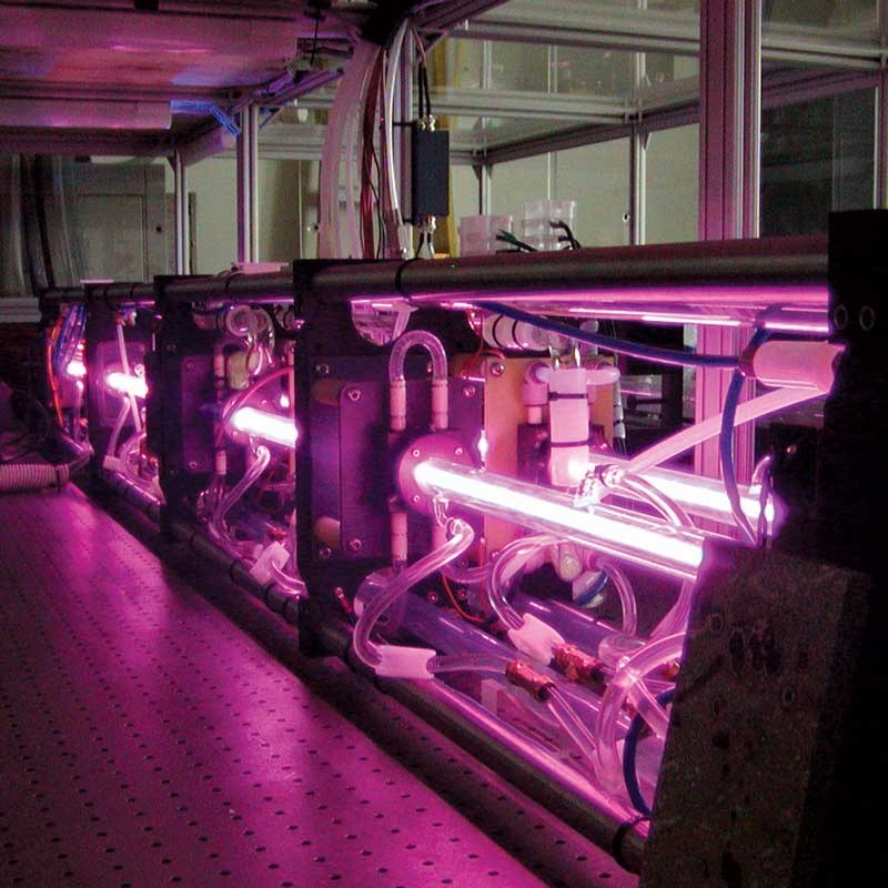Physics equipment glowing purple in a UMass Lowell laboratory