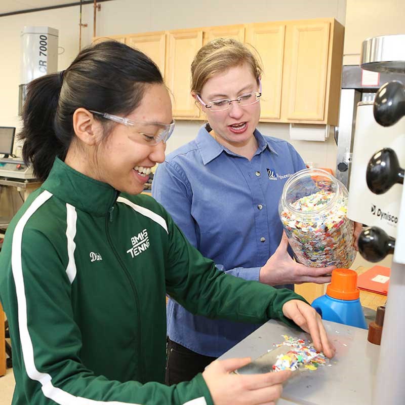A student and professor work in a UMass plastics engineering lab