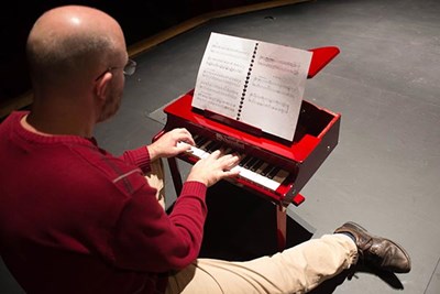 Aaron Rosenberg plays his toy piano