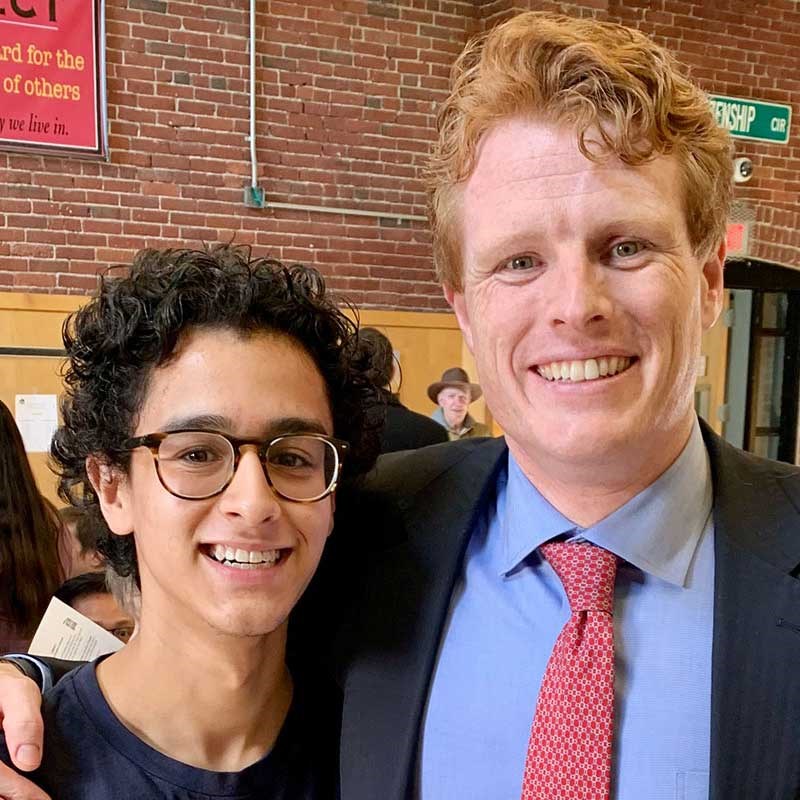 UMass Lowell political science student stands next to Joseph Kennedy III