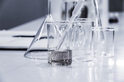 Glass Beakers and Pipets on a Table