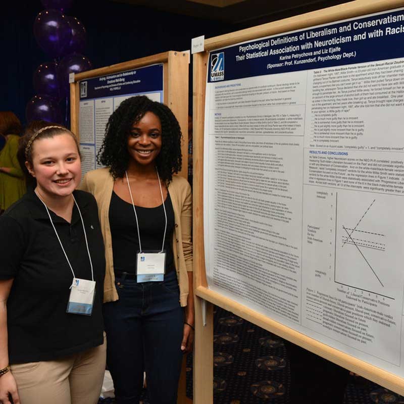 Two students present their poster at the Student Research Symposium.