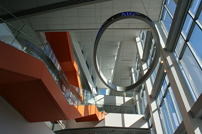 Lobby of Pulichino Tong Business Center at UMass Lowell showing stock ticker