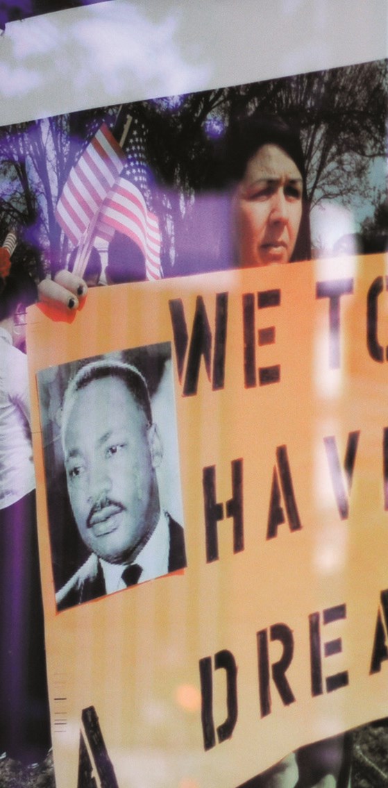A person holding a Martin Luther King Jr. poster at a rally