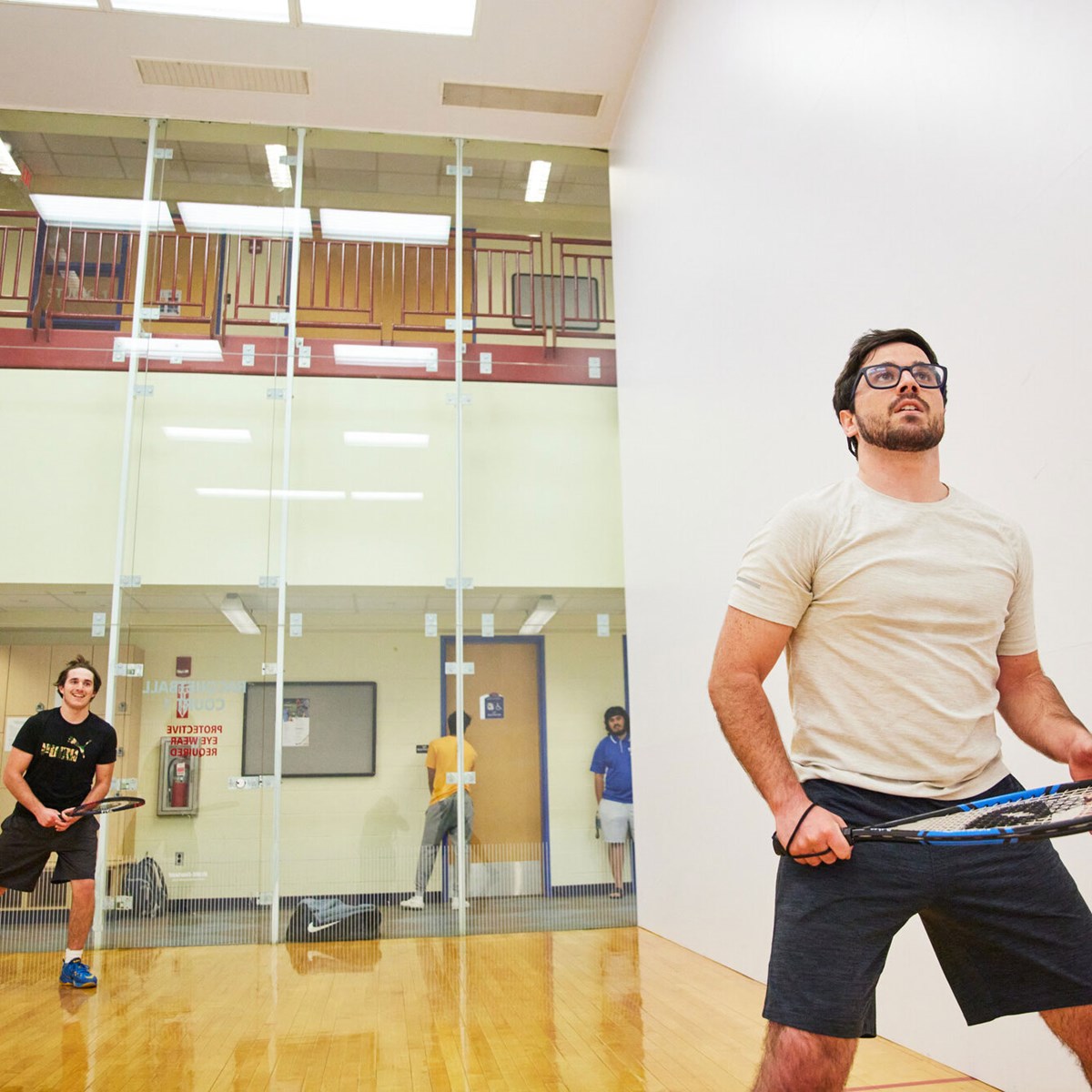 two young men on play racquetball
