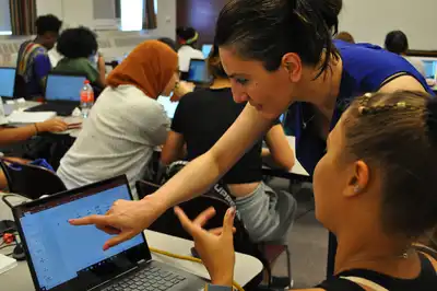 Prof. Gulden Camci-Unal , Assistant professor in Chemical Engineering is working with the students on a project related to her research on paper based bio-sensors and is helping a student design the template on a computer.