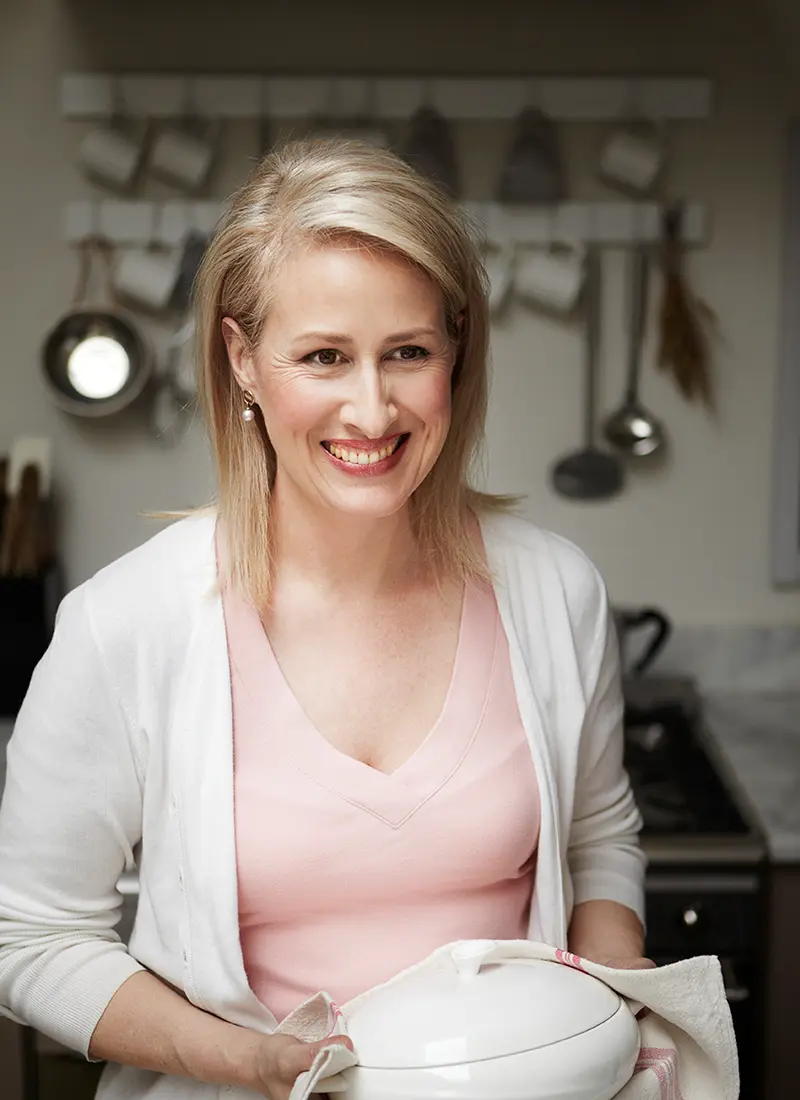 Renee Elliott, founder of Planet Organic, holds a ceramic container in a kitchen