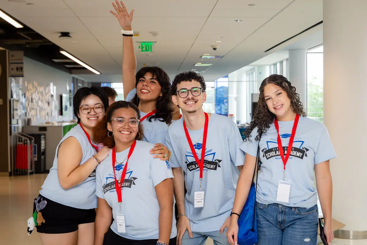 River Hawk Scholars Academy (RHSA) students pose for a photo indoors. 