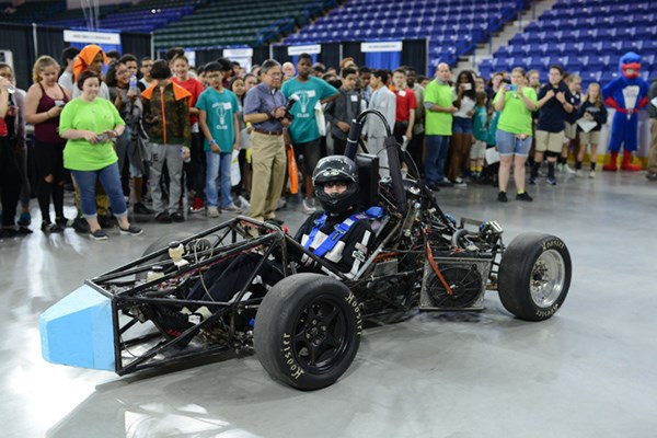 River Hawk Racing team brings their car out in front of a crowd and Rowdy at an event at the Tsongas Center