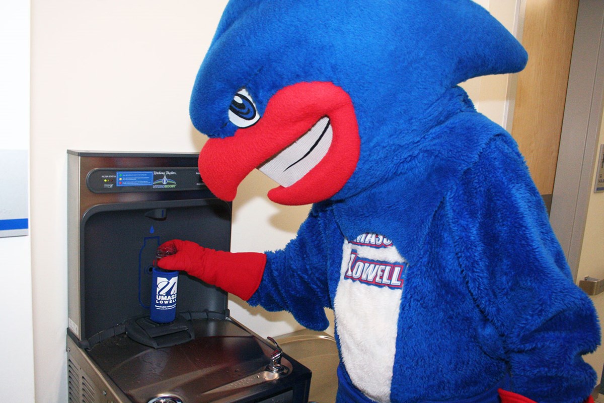 UMass Lowell mascot, Rowdy the River Hawk, fills up a reusable water bottle at one of the hydration stations located across the campuses. Having Hydration Stations easily accessible throughout campus reduces the usage of single-use water bottles.