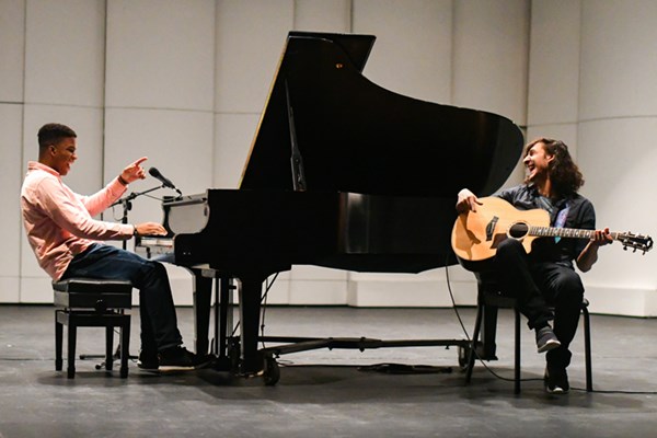 Dominik Hyppolite on piano and Alec Anand on guitar share a lighter moment during rehearsal