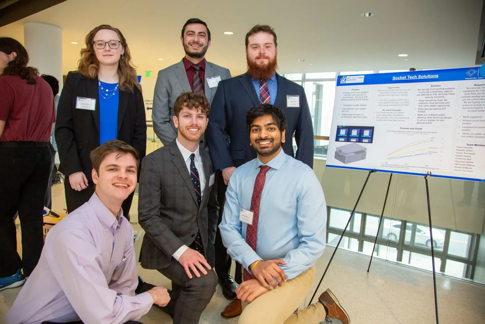 Team Socket Tech Solutions taking a photo with their poster at the 2024 $50,000 Idea Challenge.