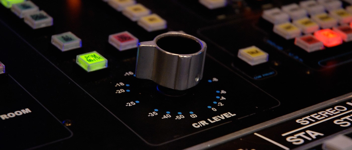 A close up of a knob on a soundboard in a studio of the Sound Recording Technology program.