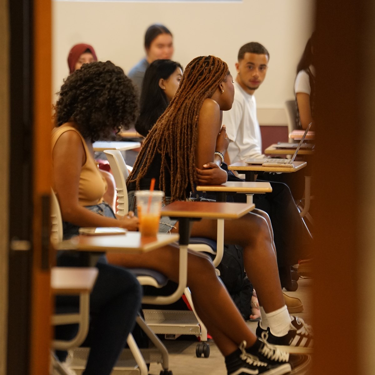 Students sit at desks in UMass Lowell Souyh Campus classroom