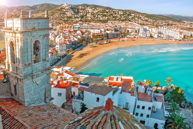 Coastal Spanish city with buildings with orange tiled roofs