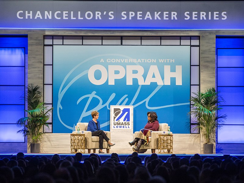 UMass Lowell Chancellor Jacquie Moloney on stage with Oprah Winfrey at the Chancellor's Speaker Series
