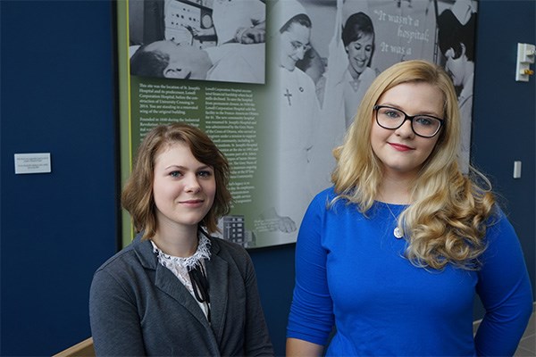 Kim Cosgrove (left) and Kady Phelps created an exhibit about the history of St. Joseph’s Hospital