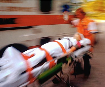 Blurred image of a person on a stretcher.