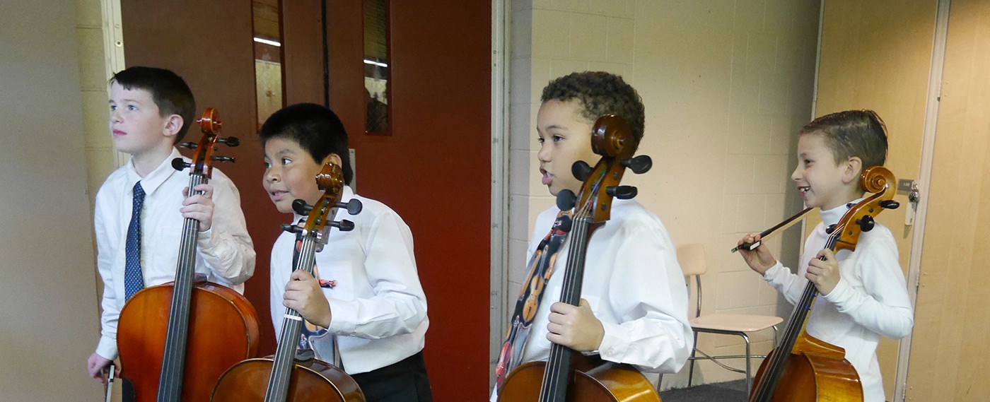 Young Cellists from the string project wait backstage before their concert.