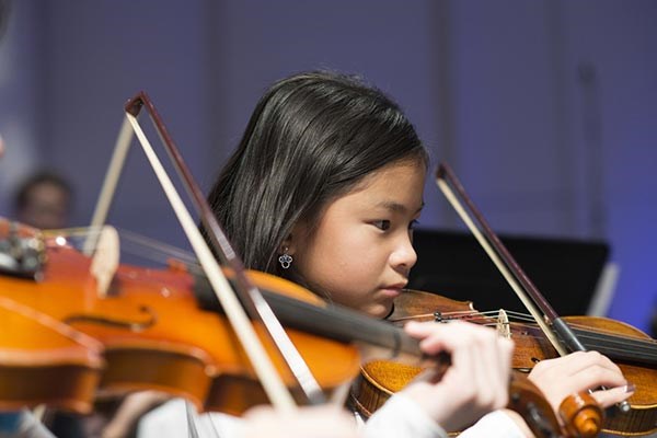 Strings Project student plays violin.