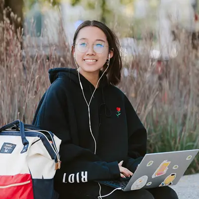 female-student-on-laptop-outdoors