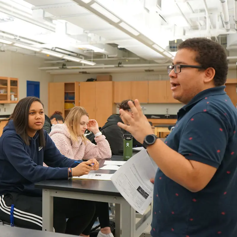 A UMass Lowell student teaches in a high school classroom.