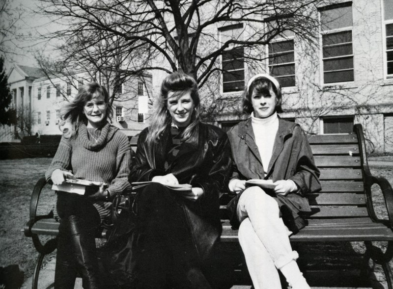  Three female students sit on bench on North Campus outside Southwick in 1992
