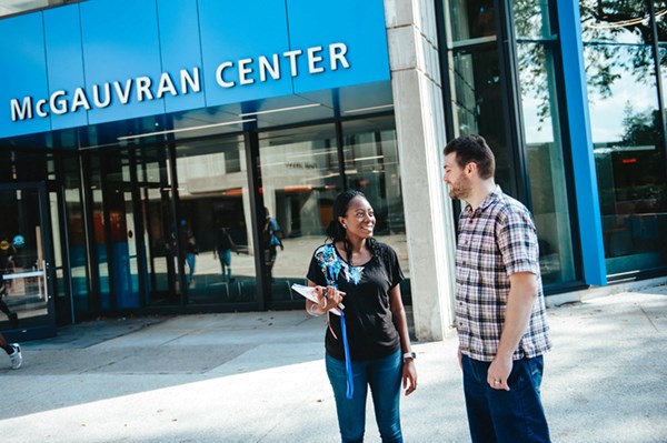 Two students talk outside of McGauvran Center at UMass Lowell