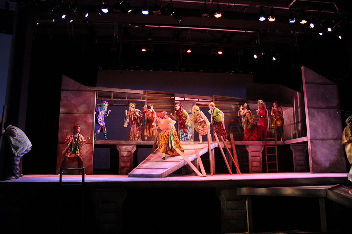 Students performing on stage during a UMass Lowell Theatre Arts production.