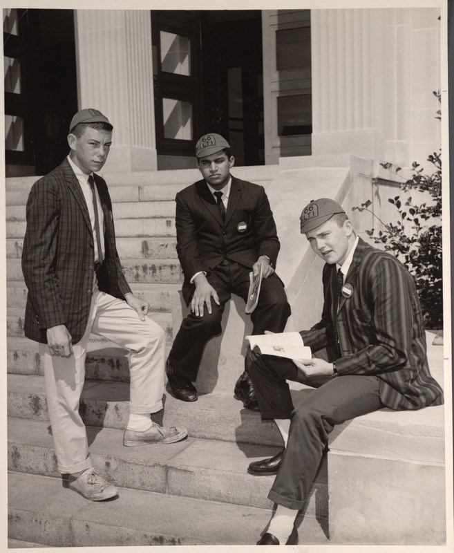 Three male students hang out on the steps of Cumnock Hall in 1966