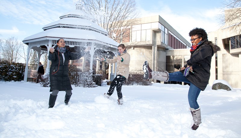 UMass Lowell students play in the snow on South Campus