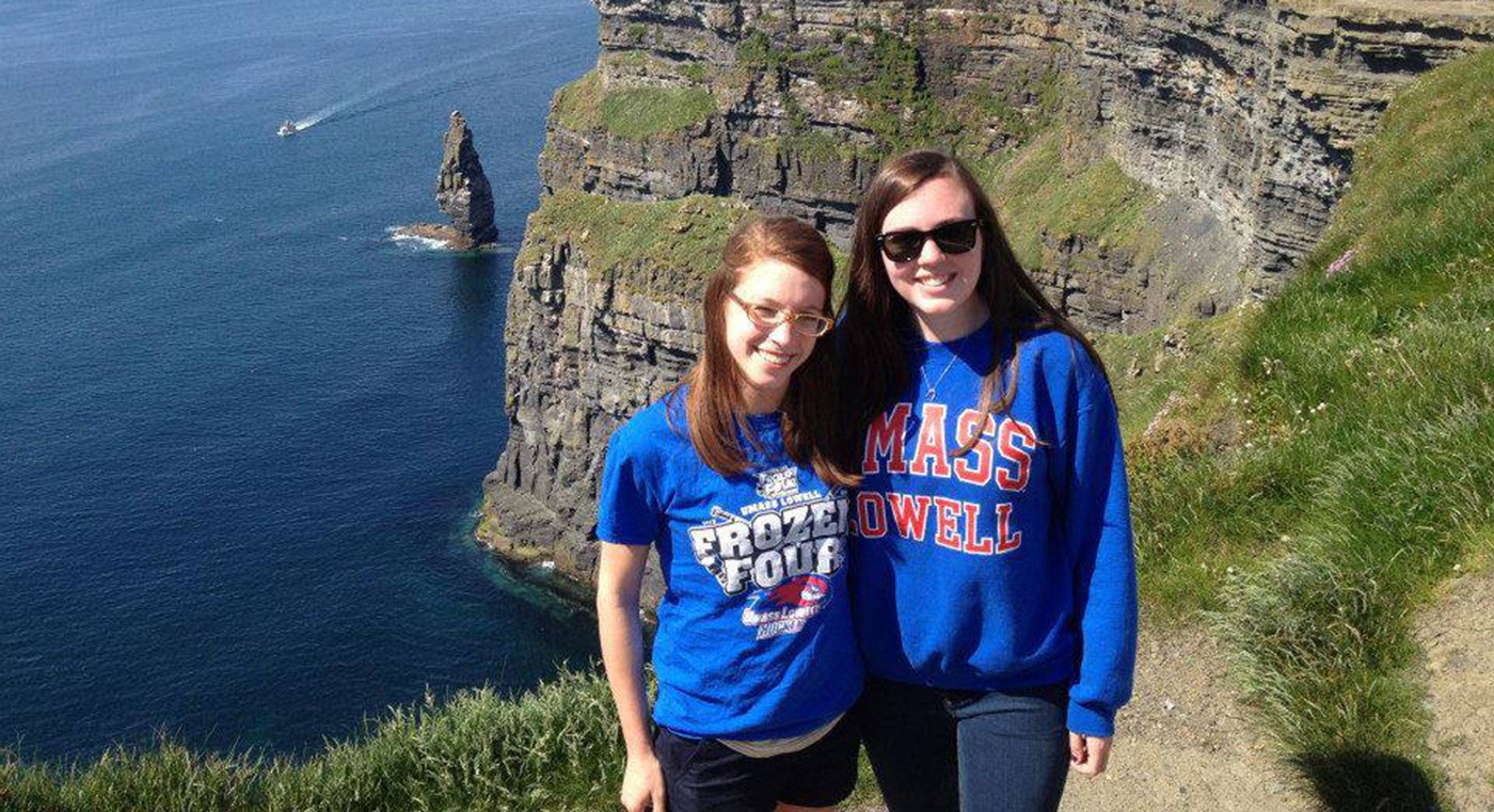 Two female UMass Lowell students pose for a photo on the Irish coastline.