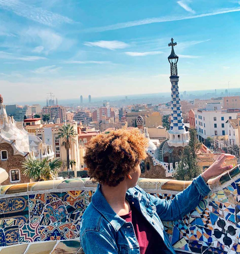 A study abroad student looks over Barcelona from a balcony
