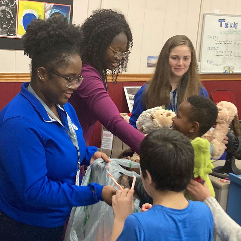 Students share stuffed animals with children