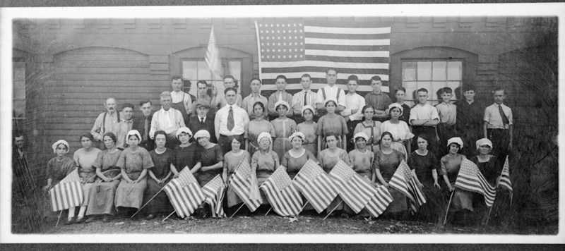 Group photo of Suffolk Mill workers with American flags