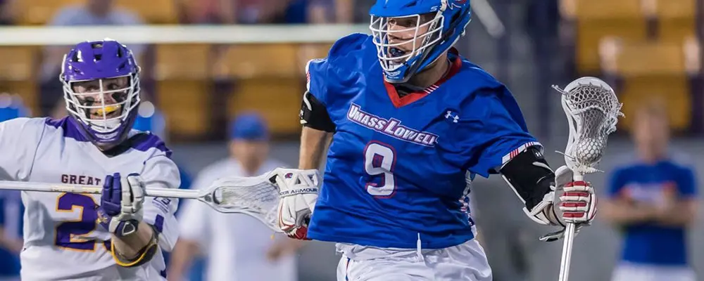 Two young men playing lacrosse