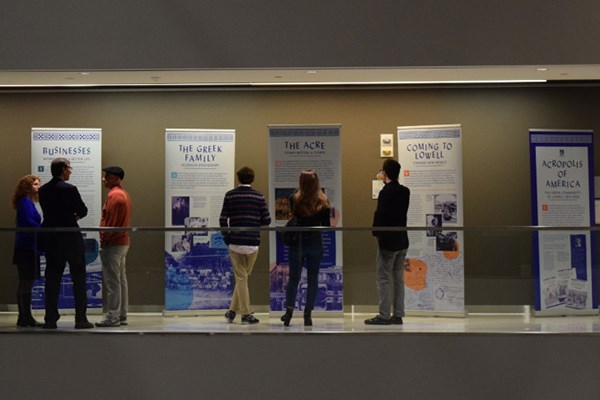 People browse the exhibit at UMass Lowell's University Crossing